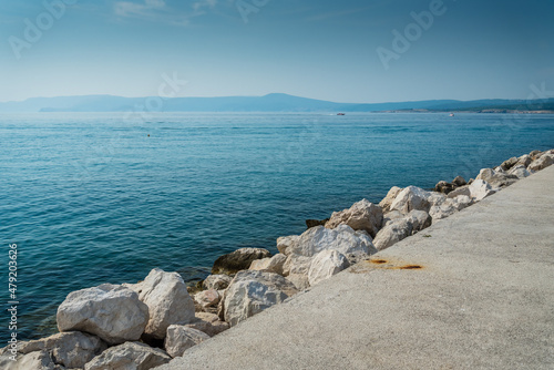 The quay of Crikvenica with stones under blue sky. Crikvenica is a popular holiday resort in Kvarner riviera in Croatia