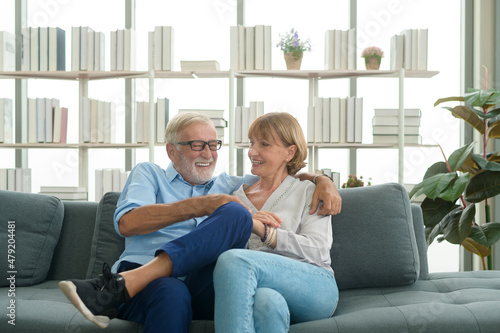 Happy Caucasian senior couple relaxing in living room at home