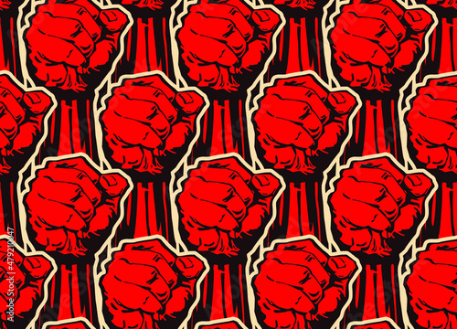 Vector seamless pattern of strong raised red fists in the style of soviet propaganda posters.