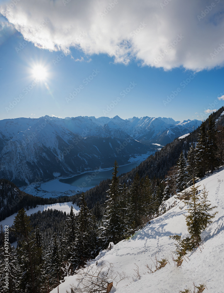 view from Rofan alps to lake achensee and mountain range, austria in winter