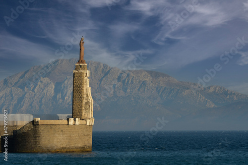 The entrance to the port and the breakwater of the Sacred Heart of Tarifa in Cadiz, Andalusia Fototapet