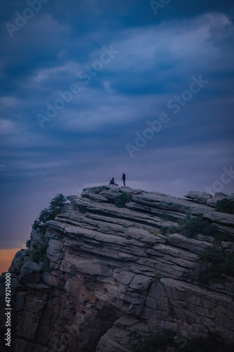 silhouette of a person standing on a rock © Guillaume