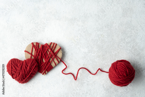 Two hearts made of red woolen yarn  Valentine s day concept.
