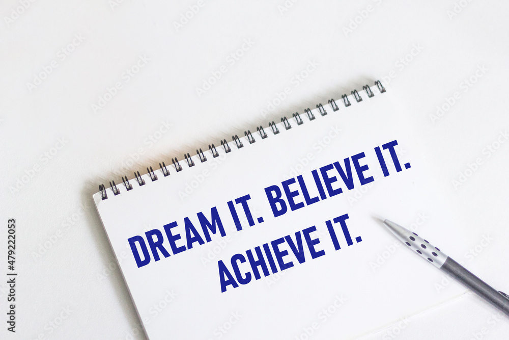 Obraz premium Dream. Believe it. Achieve this. Inspirational motivational quote on notepad and white background.