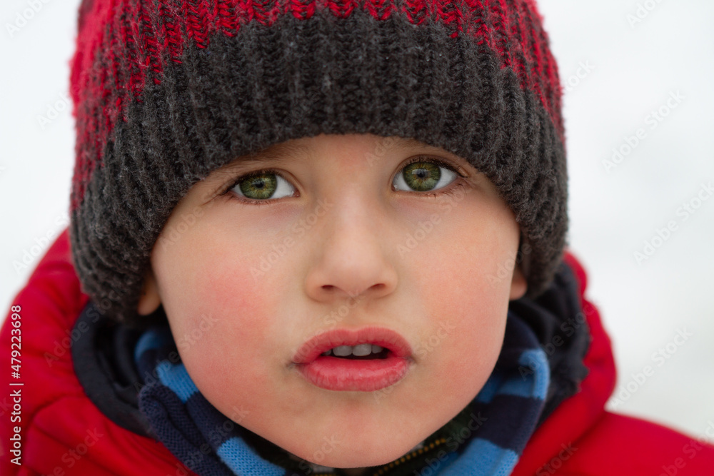 Portrait of a boy in winter clothes in the park Portrait of a boy in winter clothes in the park