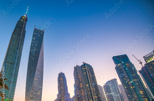 Photography Buildings of Dubai Marina at night. Skyscrapers along the water.
