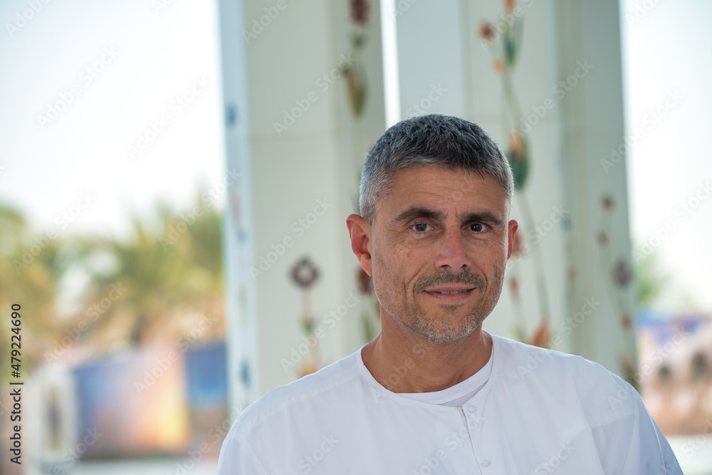 Happy caucasian tourist visits the Abu Dhabi Mosque. Happy caucasian tourist visits the Abu Dhabi Mosque.