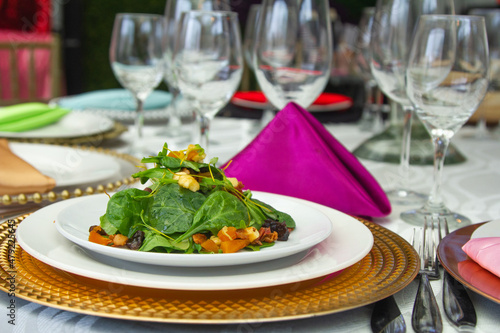 Laid table with vegetables, salads and drinks. Festive table with food. Elegant meal