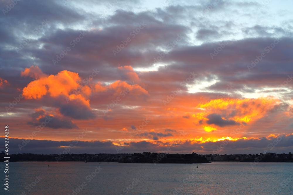 Colorful sunset sky in winter over the Atlantic Ocean in Saint Malo, Brittany, France.