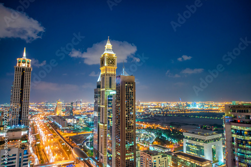 Downtown Dubai skyscrapers along Sheikh Zayed road  aerial view at night.