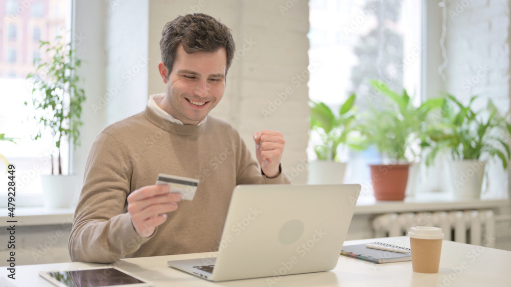 Man making Successful Online Payment on Laptop Man making Successful Online Payment on Laptop