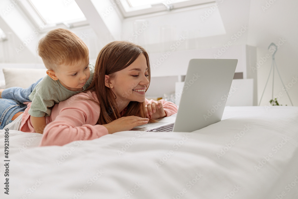 Child interested looking at the laptop screen Child interested looking at the laptop screen