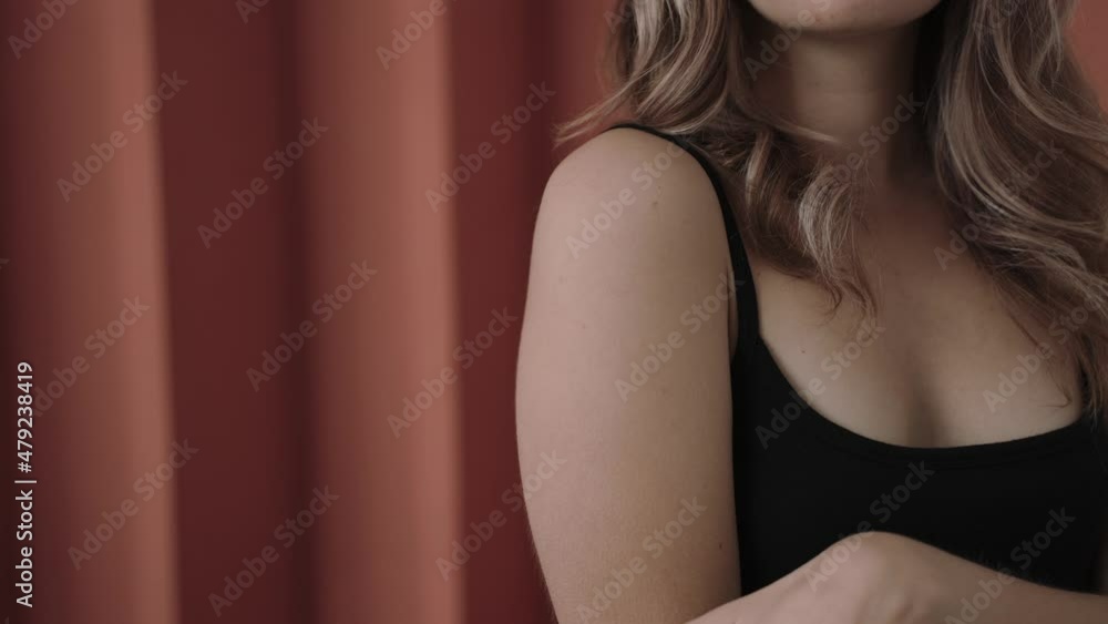 Close shot of woman's hands touching her body in pink studio, natural beauty. Young woman in black shirt standing in pink studio. High quality 4k footage Close shot of woman's hands touching her body in pink studio, natural beauty. Young woman in black shirt standing in pink studio. High quality 4k footage