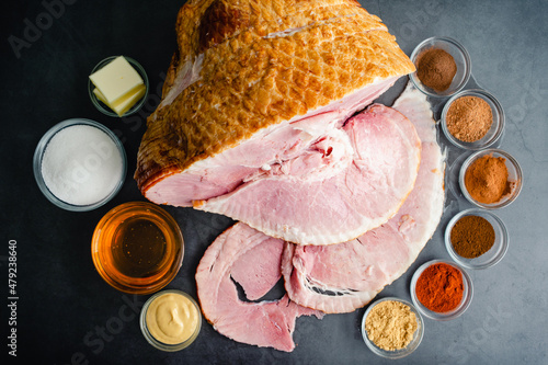 Ingredients for a Glazed Spiral Cut Ham: A smoked ham with honey, sugar, and spices to make a glaze photo