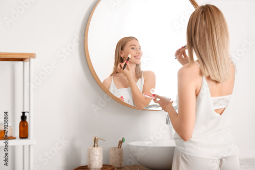 Pretty young woman applying...