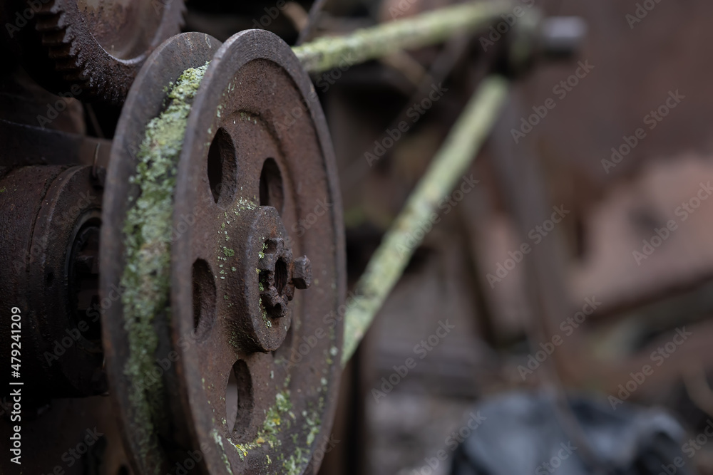 gears rollers of an old rusty motor on the farmyard