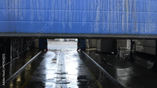 Dirty truck wash blue gate rolls up in winter time. Olomouc CSAD, Czech Rep