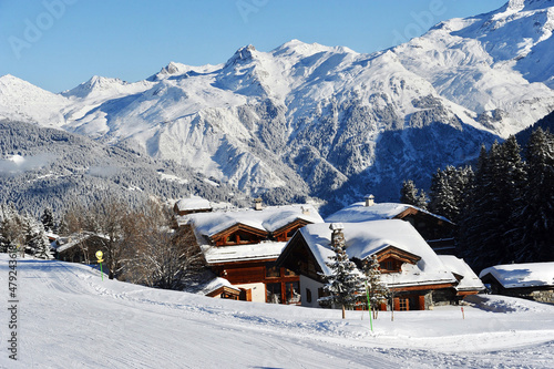 Courchevel ski resort village in winter with Mont Blanc mountain behind 