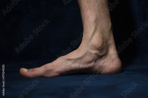 bare man's foot on a dark background