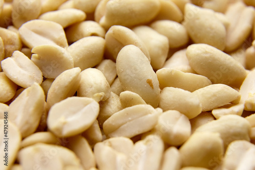 Raw blanched peanuts as food background
