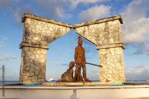 Monument of two cultures. Statue featuring Mayan warrior on the Cozumel, Mexico waterfront photo
