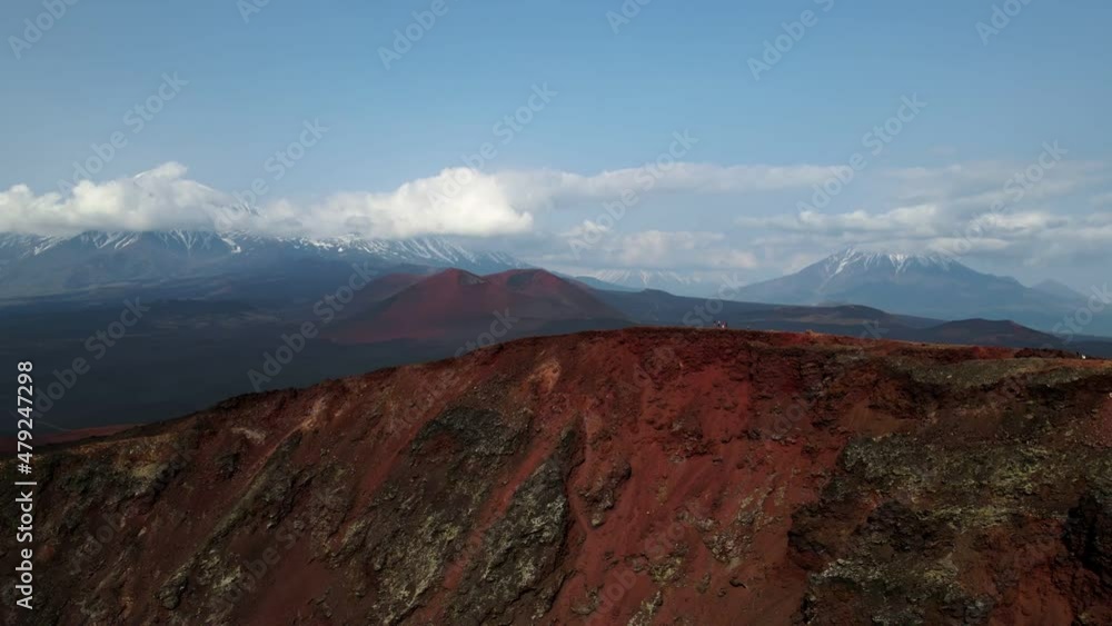 red mountain with a view of snow volcanoes red mountain with a view of snow volcanoes