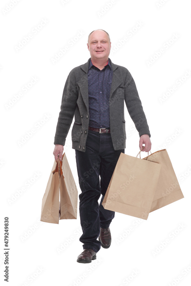 cheerful casual man with shopping bags .isolated on a white background. cheerful casual man with shopping bags .isolated on a white background.