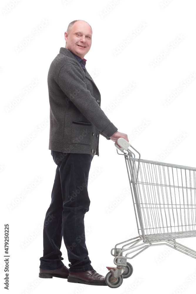 smiling casual man with shopping cart .isolated on a white background. smiling casual man with shopping cart .isolated on a white background.