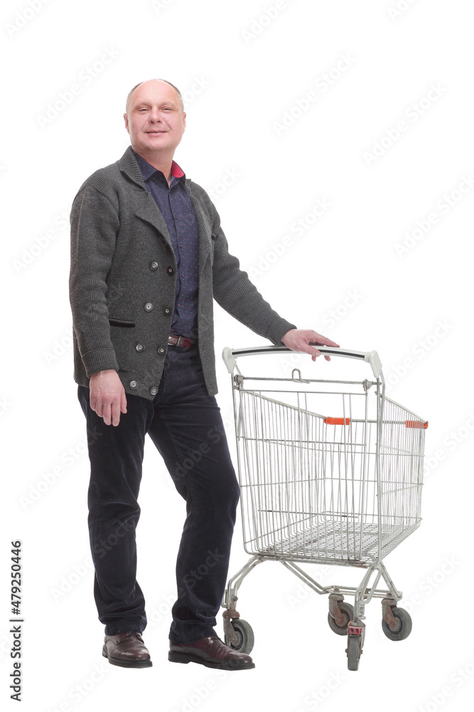 smiling casual man with shopping cart .isolated on a white background. smiling casual man with shopping cart .isolated on a white background.