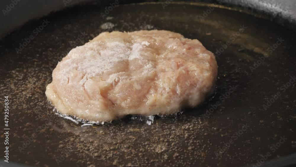 The raw rissole cutlet on the hot cooking oil inside the frying pan .close-up.4K UHD The raw rissole cutlet on the hot cooking oil inside the frying pan .close-up.4K UHD