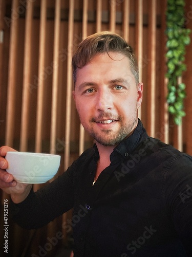 Man Enjoying a Relaxing Coffee Break in a Cozy, Modern Setting