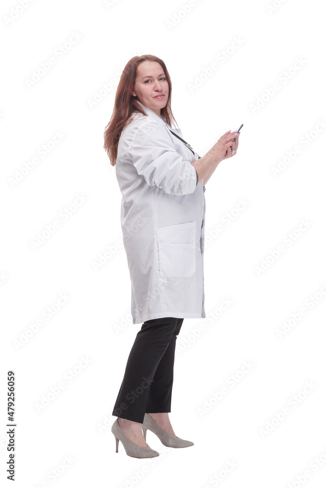 in full growth. qualified female doctor with a smartphone. in full growth. qualified female doctor with a smartphone.