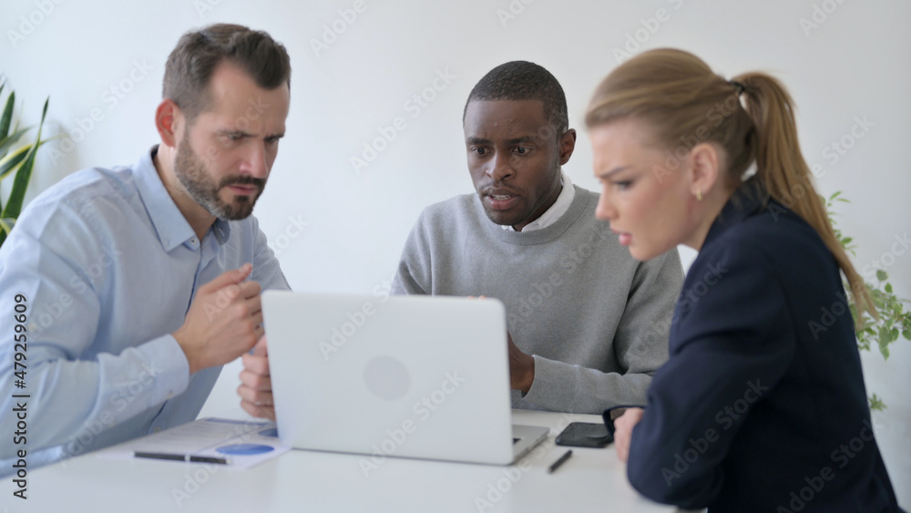 Tense Business People Waiting for Results on Laptop in Office Tense Business People Waiting for Results on Laptop in Office