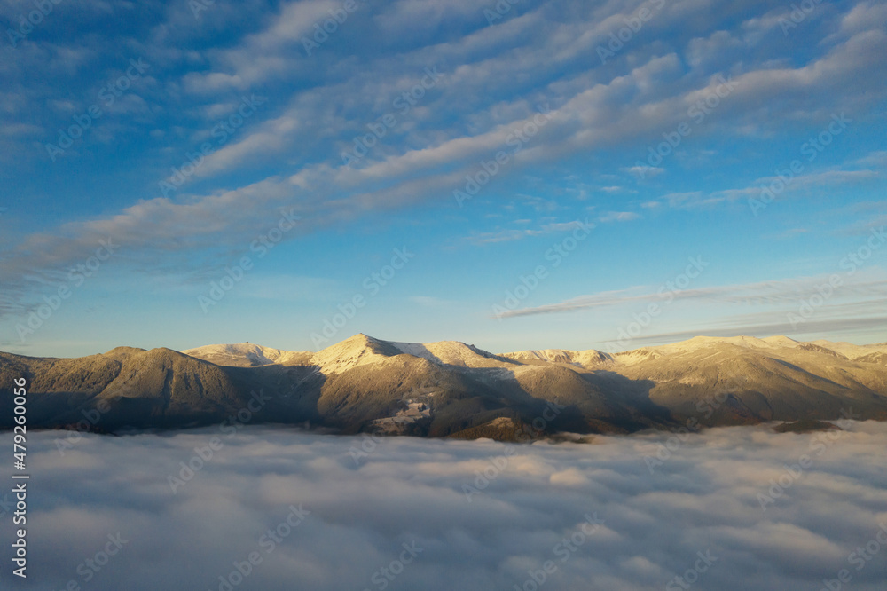 Aerial view of beautiful mountains above clouds