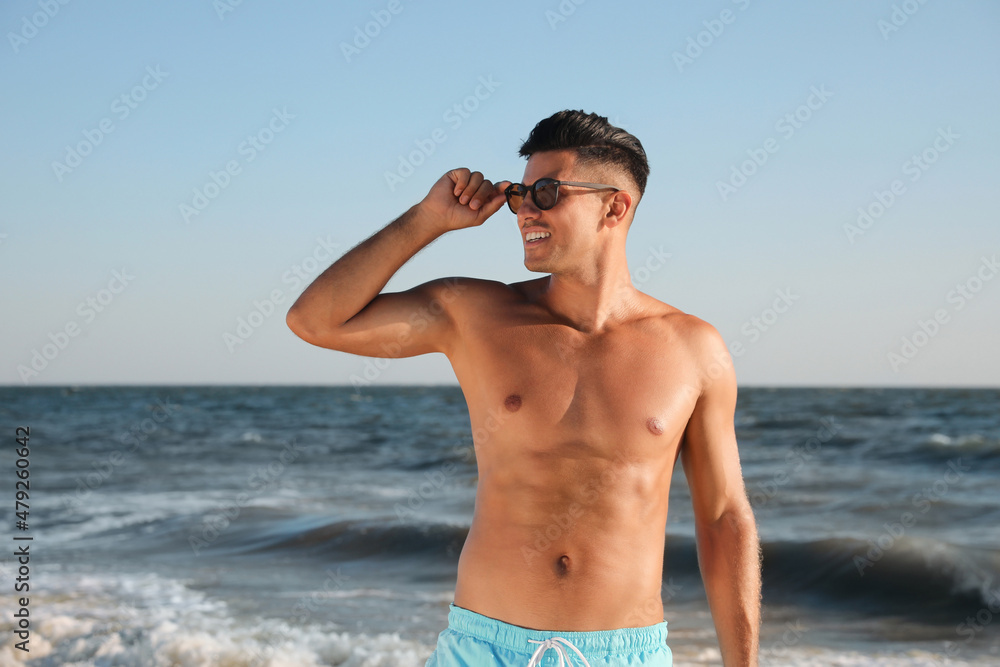 Handsome man with attractive body on beach Handsome man with attractive body on beach