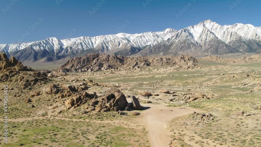 Aerial Backward Shot Of People And Off-Road Vehicle On Landscape, Drone Ascending During Winter Season - Sierra, California Aerial Backward Shot Of People And Off-Road Vehicle On Landscape, Drone Ascending During Winter Season - Sierra, California