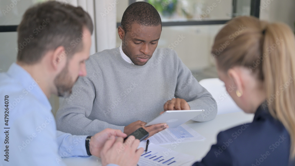 Business People using Tablet and Smartphone during Discussion Business People using Tablet and Smartphone during Discussion