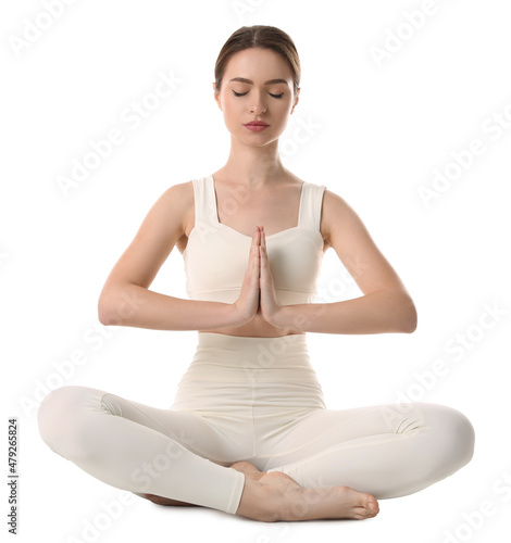 Beautiful young woman meditating on white background