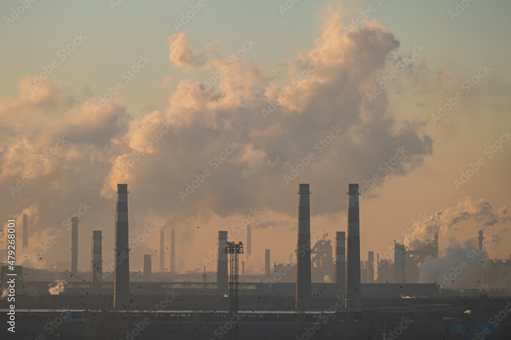 Chimneys for metallurgy. Heavy industry landscape. Air pollution from smoke and gas. Smog background. Global warming concept. Dawn industrial factory. Destruction of the ozone layer. Toxic emissions.