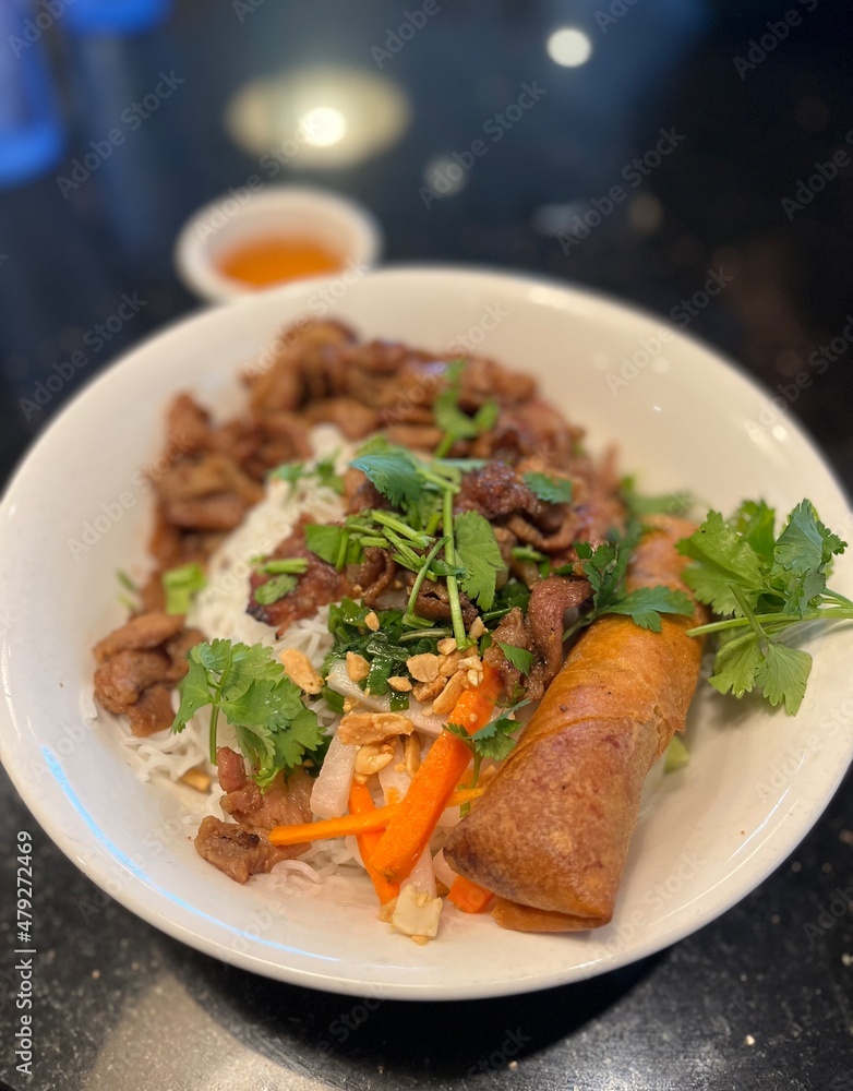 Vietnamese noodles with grilled pork and egg roll Vietnamese noodles with grilled pork and egg roll
