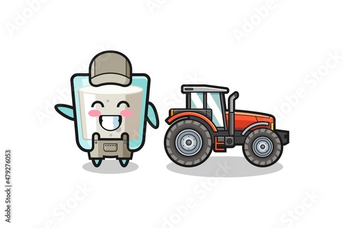 the milk farmer mascot standing beside a tractor