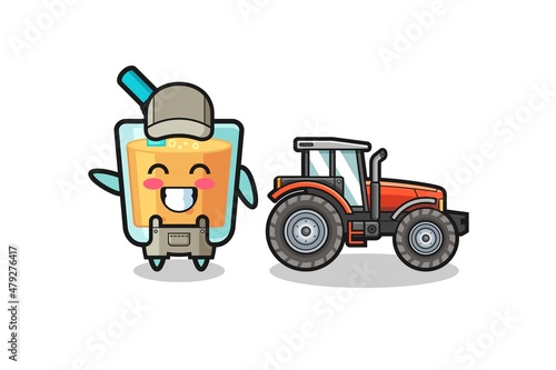 the orange juice farmer mascot standing beside a tractor