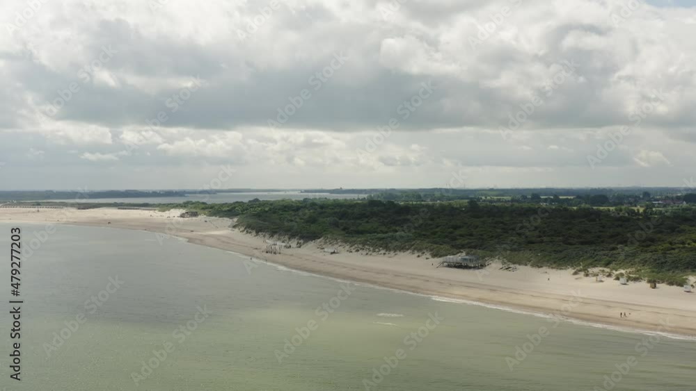 Aerial shot approaching a beach pavilion on an empty white beach in the beautiful Oranjezon nature reserve in Zeeland, the Netherlands Aerial shot approaching a beach pavilion on an empty white beach in the beautiful Oranjezon nature reserve in Zeeland, the Netherlands