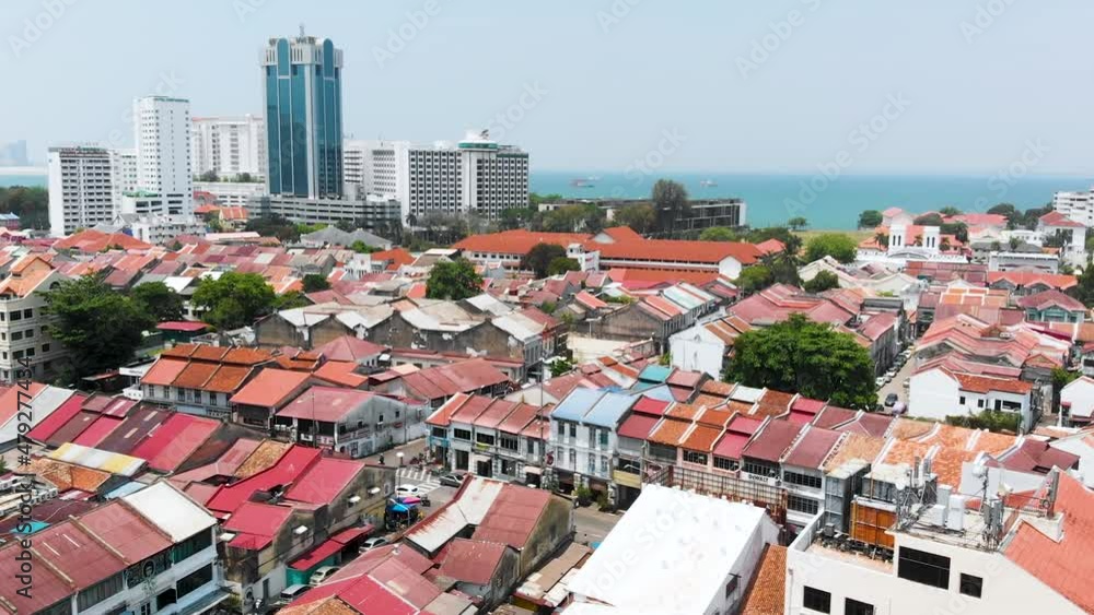 Forward Flying Drone Shot Over George Town City, Showing Buildings And The Ocean In The Background. George Town, Penang in Malaysia Forward Flying Drone Shot Over George Town City, Showing Buildings And The Ocean In The Background. George Town, Penang in Malaysia