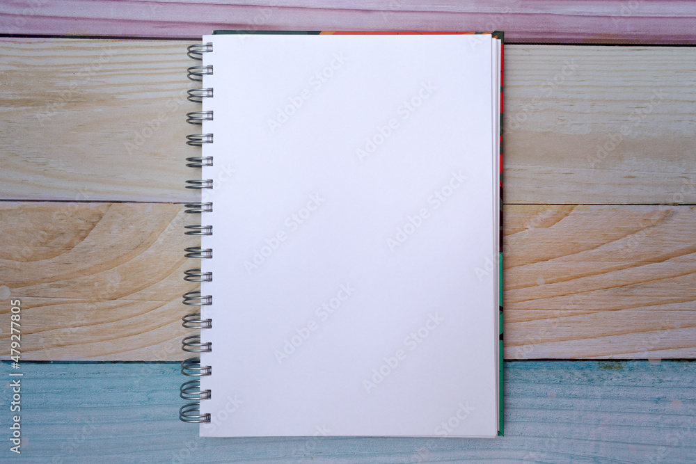 Top view of a plain white sheet notepad on a colorful madras background Top view of a plain white sheet notepad on a colorful madras background