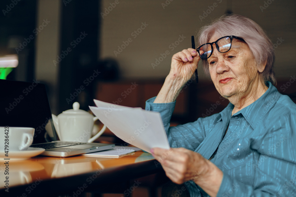 Beautiful mature senior woman sitting in a cafe with a cup of coffee and a laptop Lifestyle unaltered Beautiful mature senior woman sitting in a cafe with a cup of coffee and a laptop Lifestyle unaltered