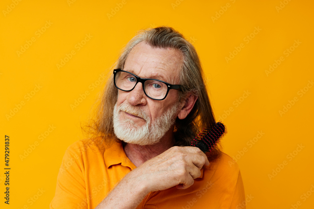 Fototapeta premium an elderly man in a yellow T-shirt with a comb gray hair
