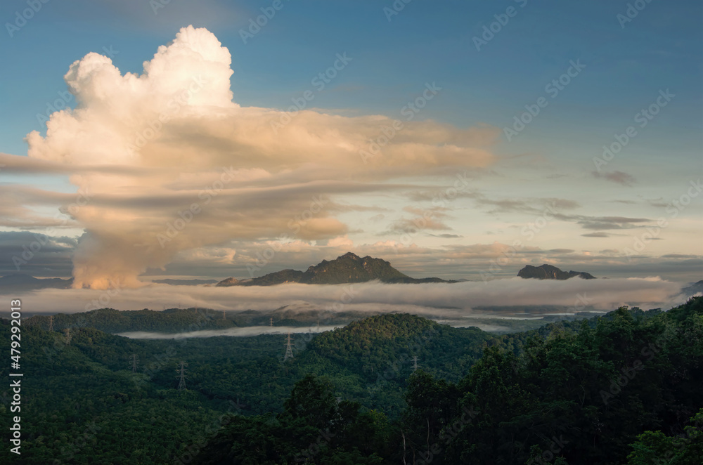 Beautiful sea of fog in the mountains, high voltage pole and steam from the coal power plant in the morning sunrise . Mae moh, Lampang, Thailand. Energy and environment concept .