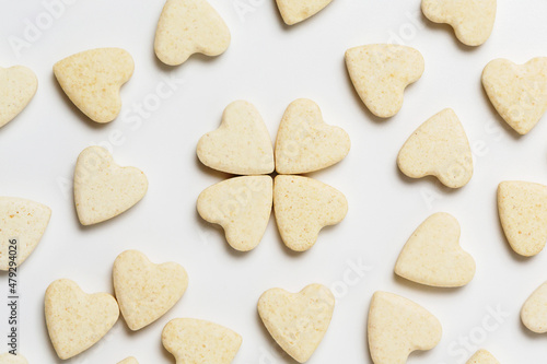 Valentine minimalistic greeting card  scattered heart-shaped sweet little cookies on white