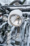 Old style bicycle  headlight covered snow.